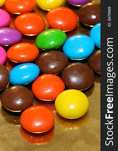 A pile of chocolate candies with a colorful outer shell