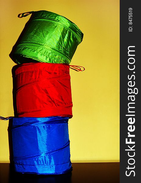 Red, green and blue metalic fabric containers. Red, green and blue metalic fabric containers