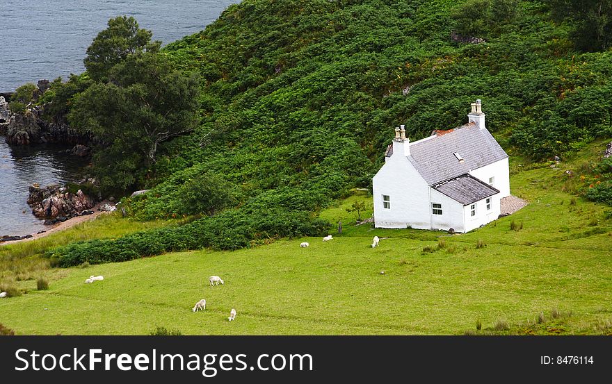 White isolated country house and green garden, scotland. White isolated country house and green garden, scotland