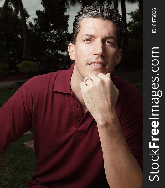 Young man posing with his hand on his chin. Young man posing with his hand on his chin