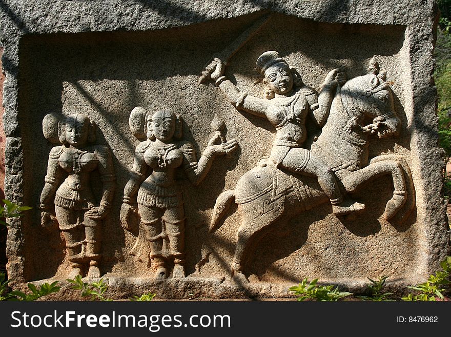 Stone etching of valorous Indian woman riding horse and fighting battle. Stone etching of valorous Indian woman riding horse and fighting battle