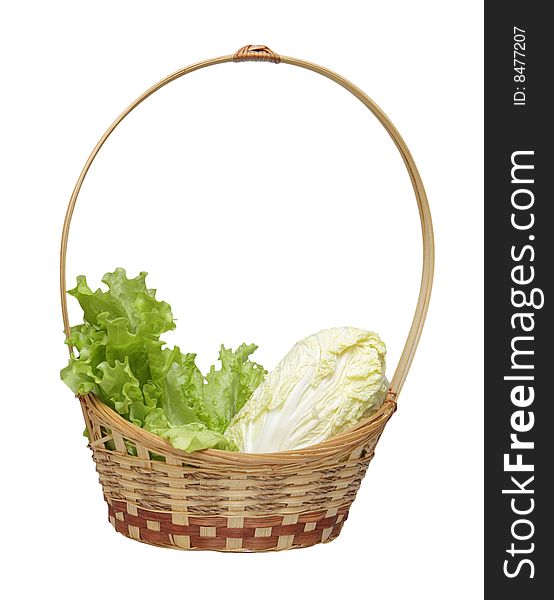 Basket with salad and cabbage isolated on a white background