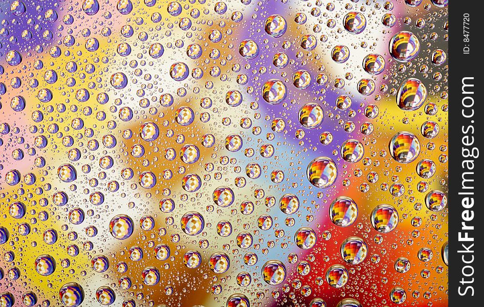 Coloured water drops on glass background. Coloured water drops on glass background