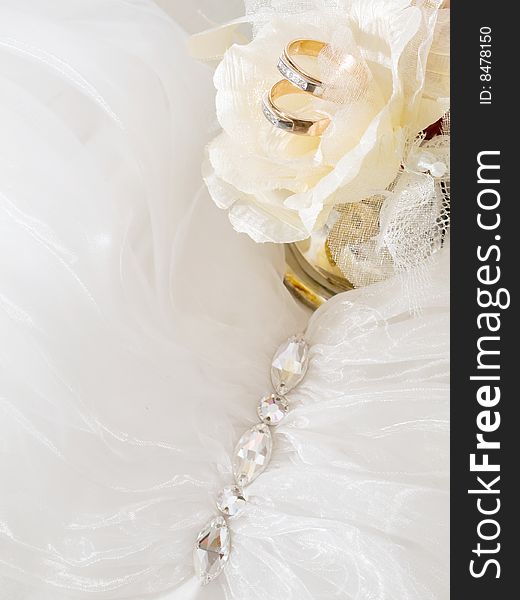 Closeup of wedding rings near decorative roses. Closeup of wedding rings near decorative roses