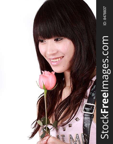 A beautiful Asian girl  holds a pink rose on white background. A beautiful Asian girl  holds a pink rose on white background.