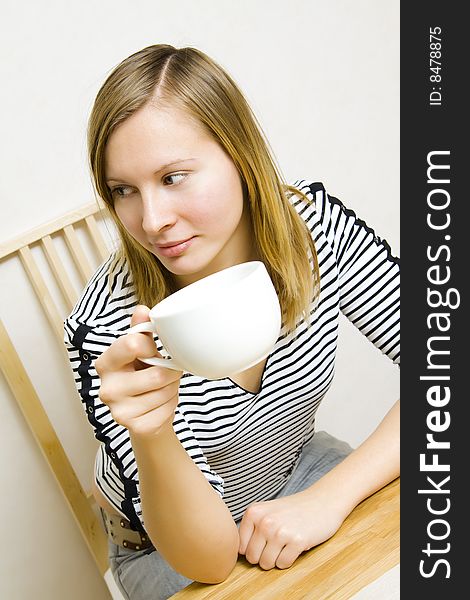 Beautiful girl holding a cup of coffee or tea. Beautiful girl holding a cup of coffee or tea