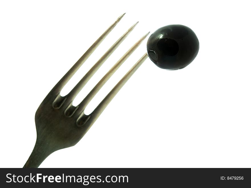 Stock photo: an image of black olive on the fork. Stock photo: an image of black olive on the fork