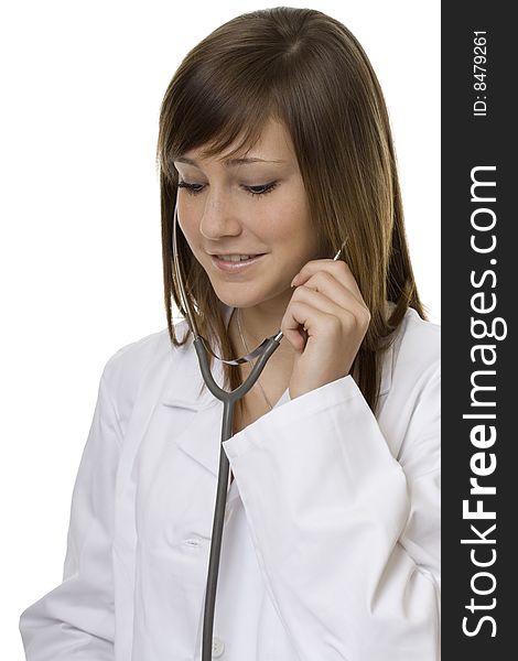 Young woman doctor with stethoscope, in a white coat against a white background