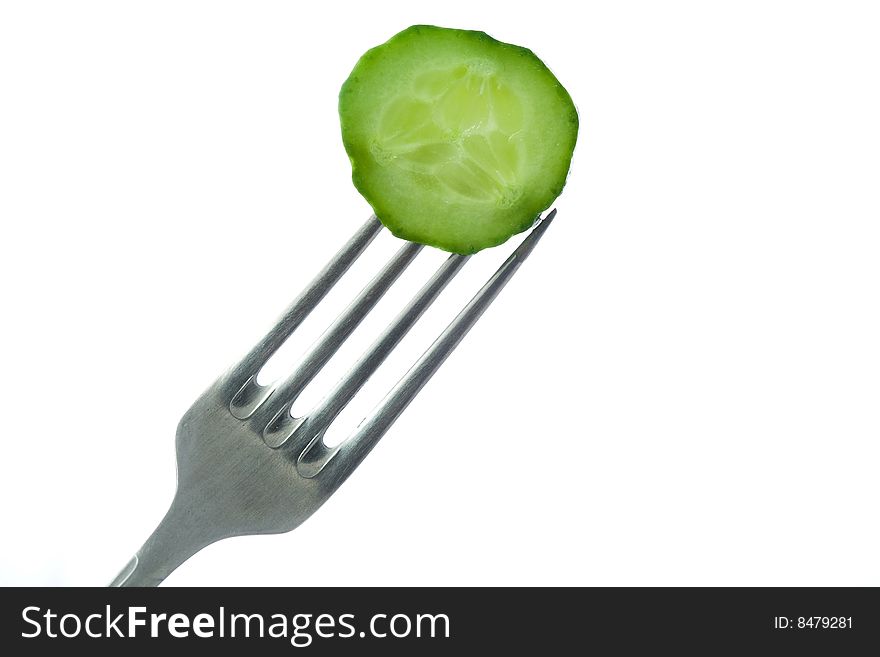 Stock photo: an image of a piece of cucumber on the fork