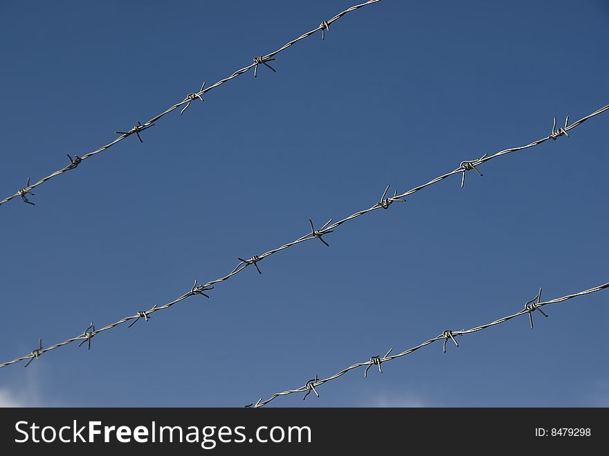 Barbed wire and the blue sky