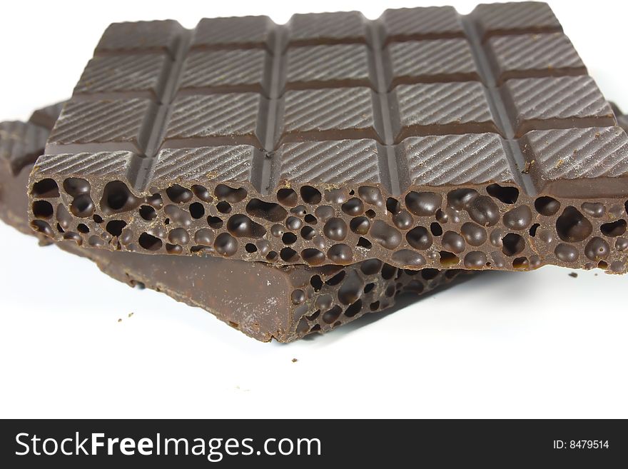 Porous chocolate, photo close up on a white background.