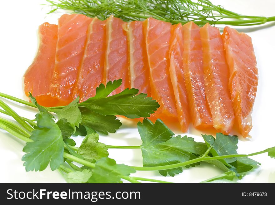 Salmon with fennel and parsley, a photo close up on a white background. Salmon with fennel and parsley, a photo close up on a white background.