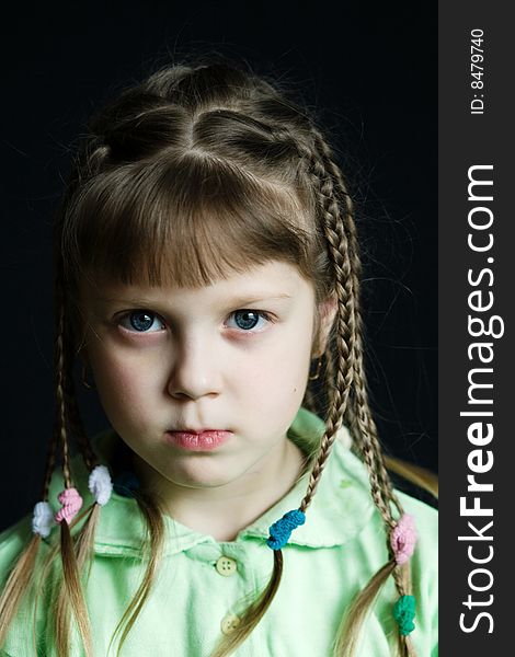 Stock photo: an image of a sad little girl with pigtails. Stock photo: an image of a sad little girl with pigtails