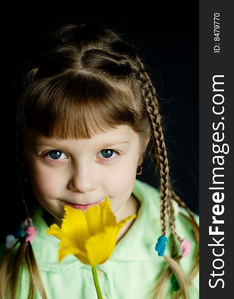 Stock photo: an image of a nice girl with a yellow flower. Stock photo: an image of a nice girl with a yellow flower
