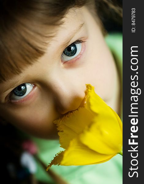 Stock photo: an image of a girl with a yellow flower. Stock photo: an image of a girl with a yellow flower