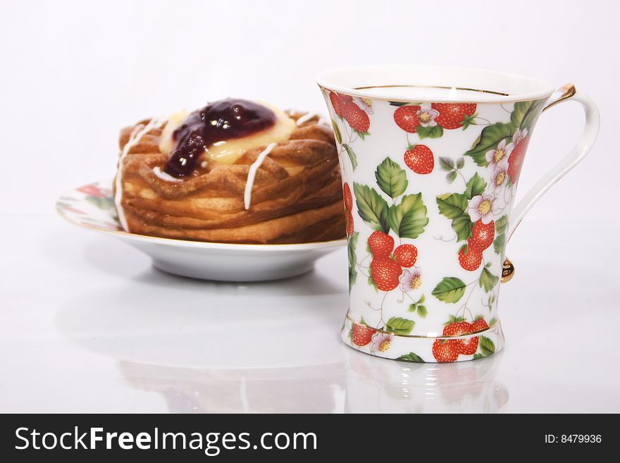 Cup and cake photo on a white background