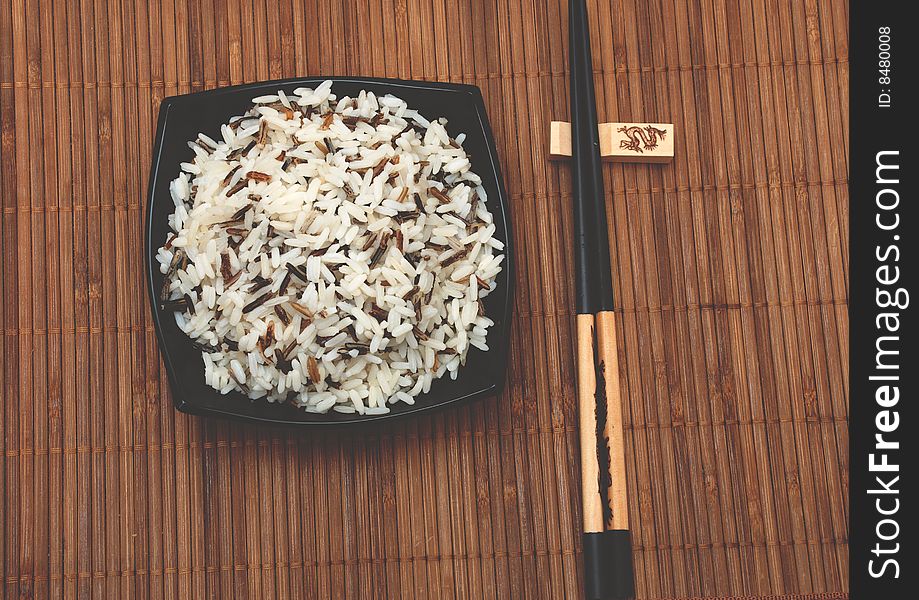 Rice in cup and chinese sticks