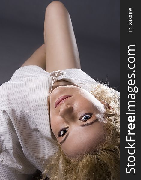 Beautiful curly blond girl wearing shirt leaning back to the camera. Beautiful curly blond girl wearing shirt leaning back to the camera