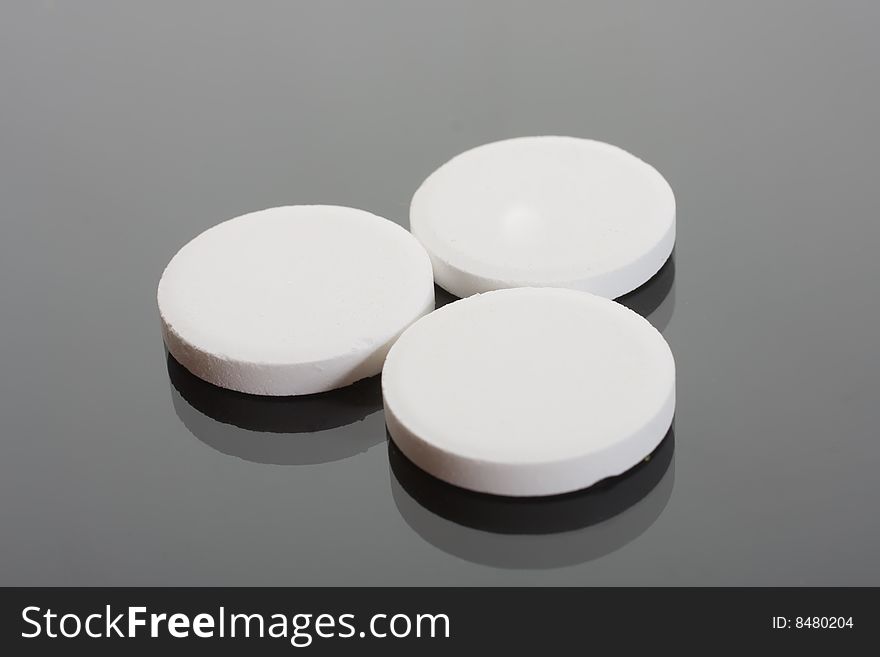 Macro of pills on glass background