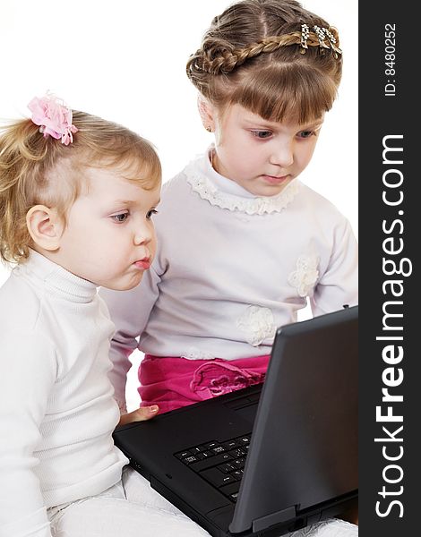 Stock photo: an image of two little sisters with laptop