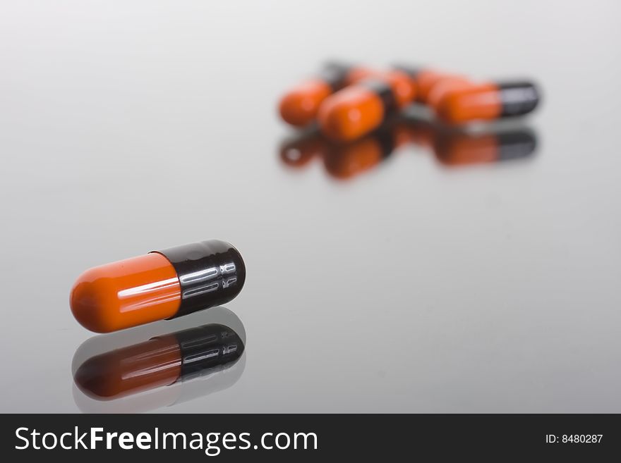 Macro of pill on glass background