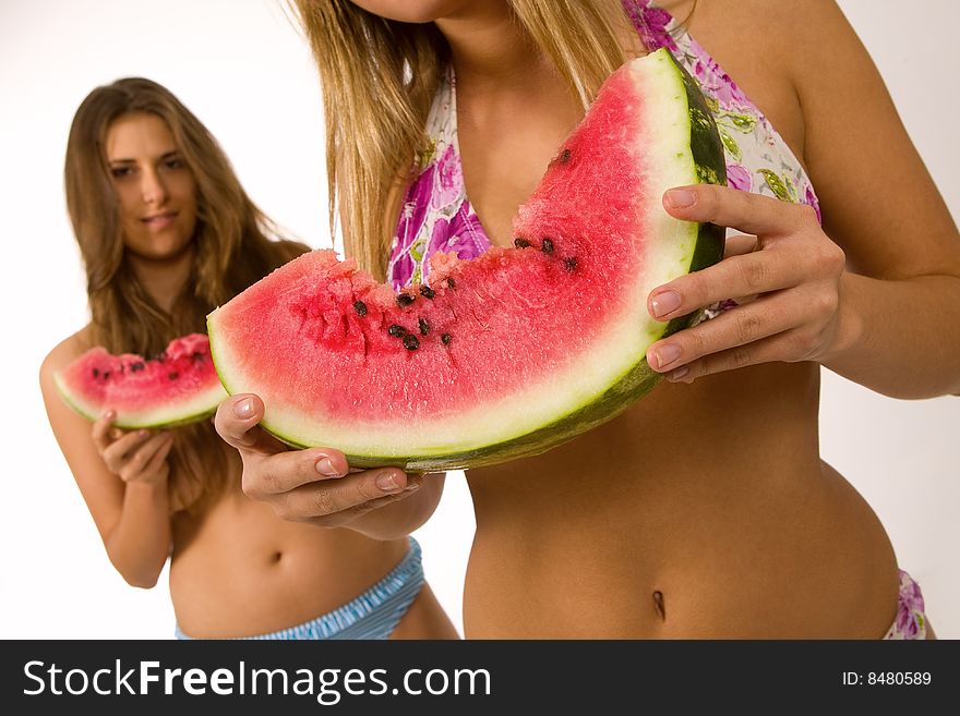 Sexy girls in bikini eating watermelon. Sexy girls in bikini eating watermelon