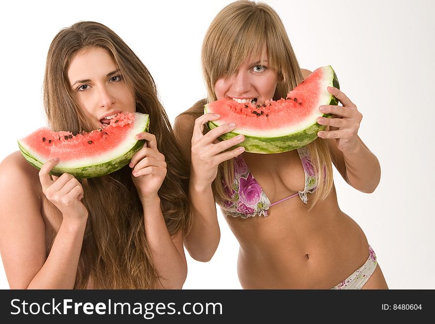 girls in bikini eating watermelon. girls in bikini eating watermelon