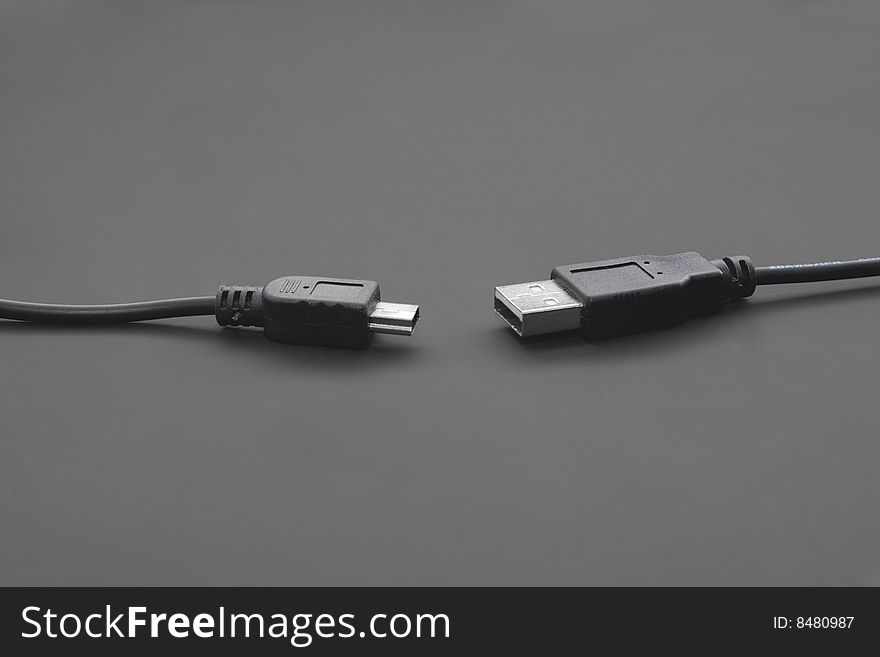 USB and miniUSB cords isolated on black. USB and miniUSB cords isolated on black