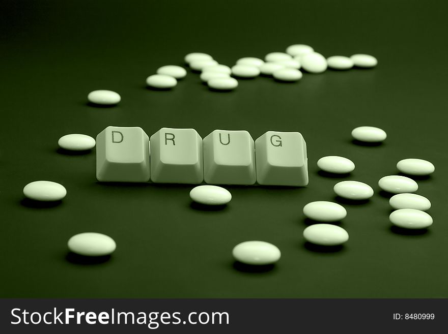 Drugs when you are ill: DRUG caption by keyboard keys and pile of pills on black