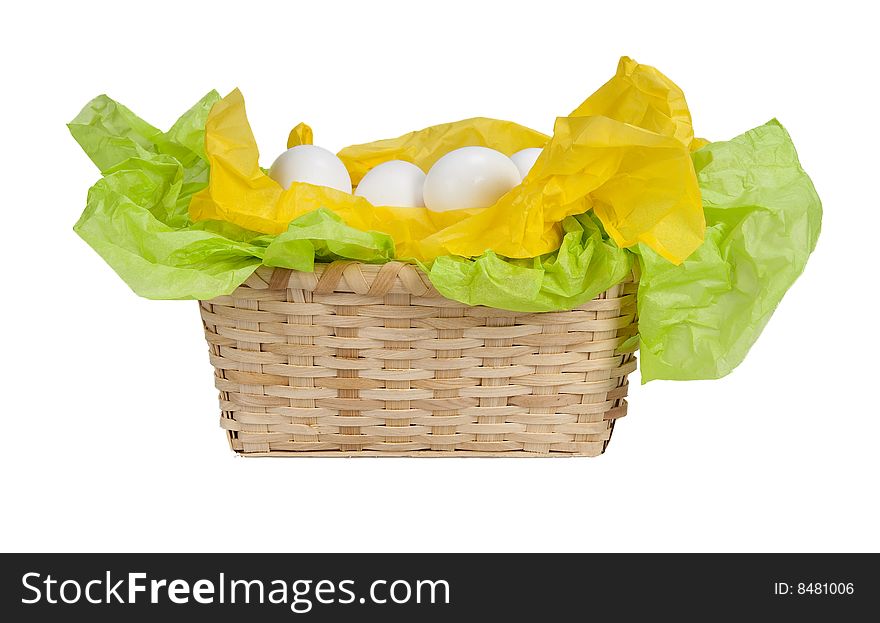 Basket with eggs and tissue paper yellow and green. Basket with eggs and tissue paper yellow and green.