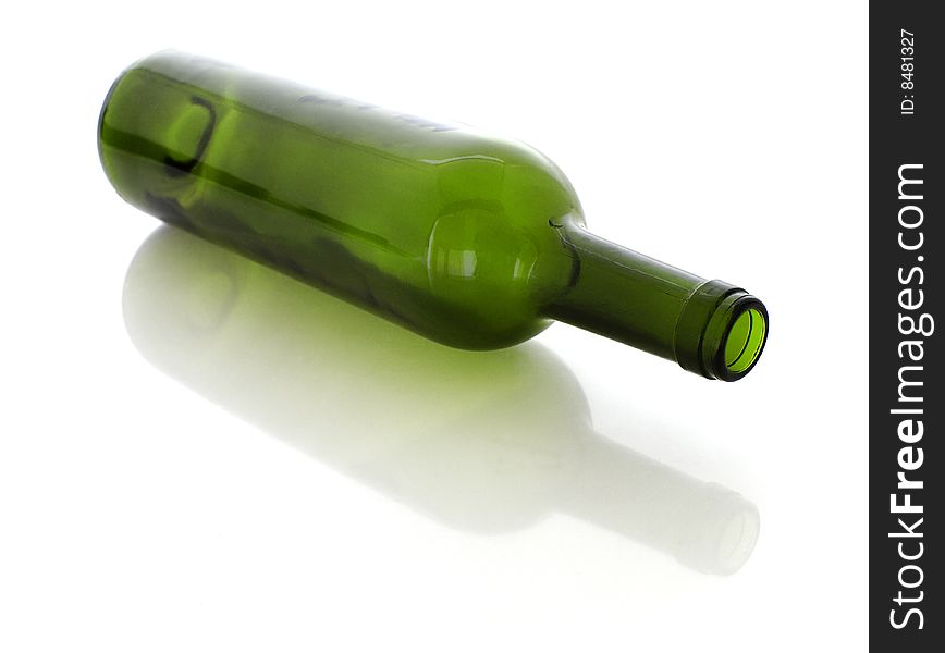 A green glass on a white background with a reflection and a shadow. A green glass on a white background with a reflection and a shadow.
