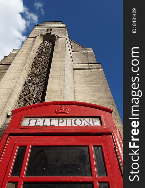 Shot of traditional British telephone box with a view of part of the Manchester Town Hall building in the background. Shot of traditional British telephone box with a view of part of the Manchester Town Hall building in the background.