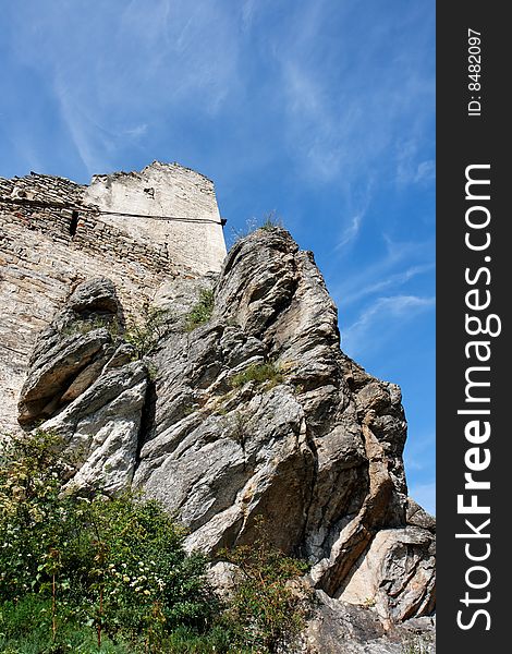 Ruins of an ancient castle on the gray furrowed rock. Ruins of an ancient castle on the gray furrowed rock