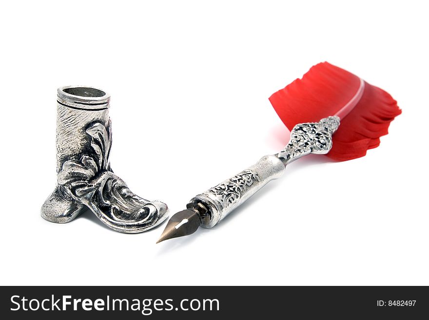 Old pen with red feather and holder isolated on white background
