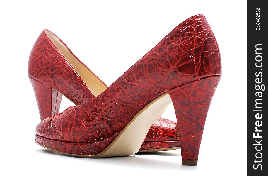 Pair of red fashionable woman shoes on white background