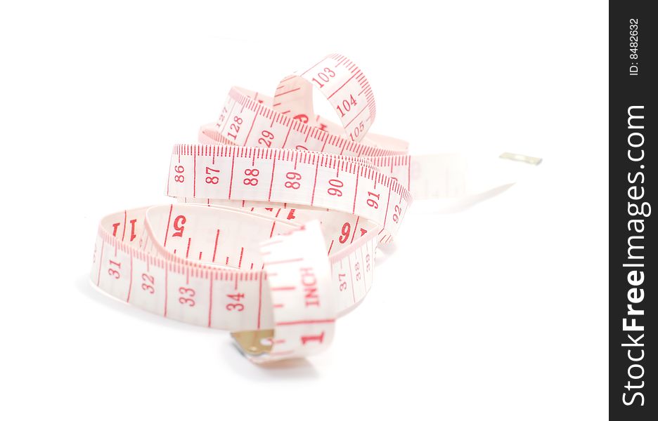 Rolled red and white measuring tape on white background