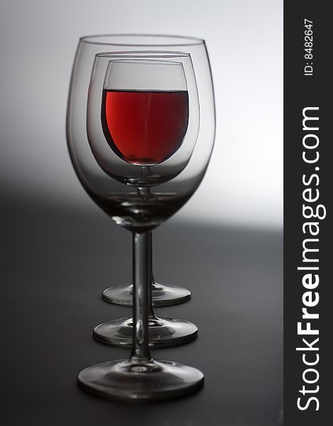 Three wine glasses on grey background