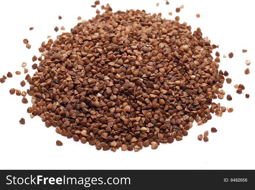 Heap buckwheat croups, disposit on white background