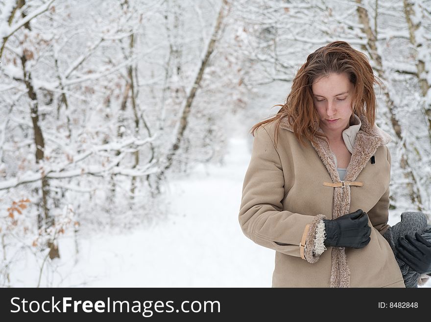 Woman standing pensive in the snow. Woman standing pensive in the snow