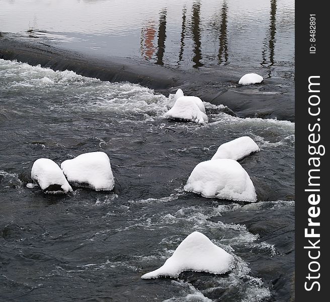 Stones In River With Snow Cover