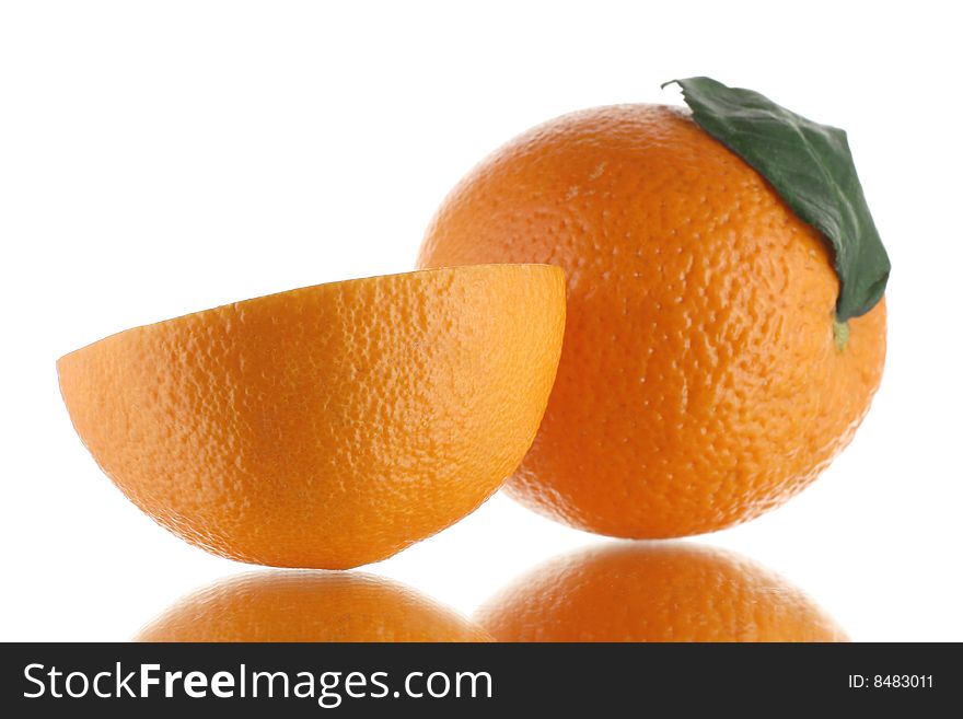Wet ripe oranges on mirror surface