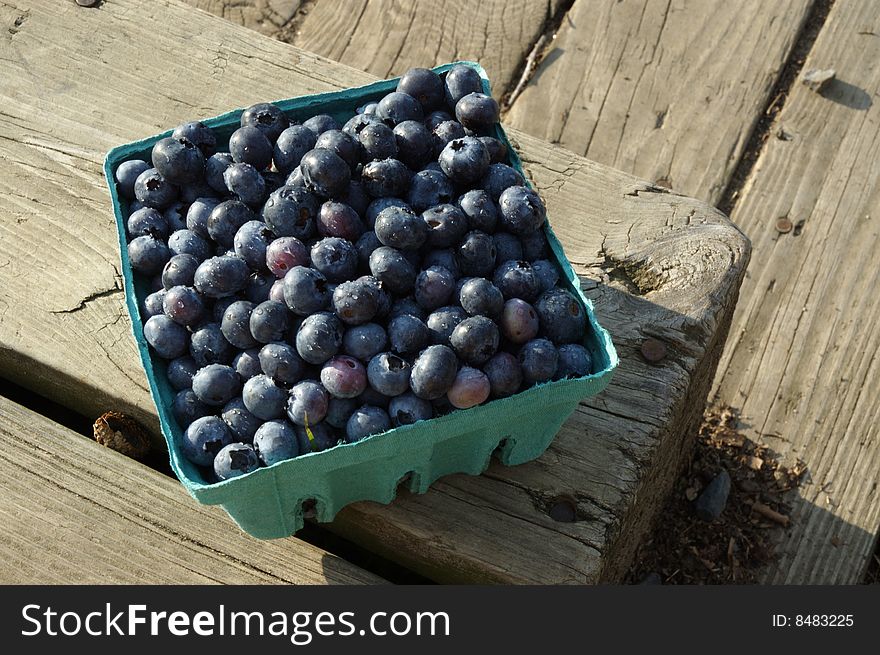 Blueberries in Pint Bucket on wooden crate