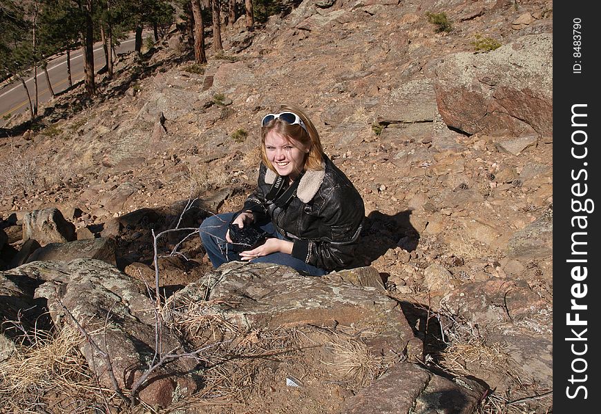 A color portrait of a women crouching down to get a new angle on a photograph. A color portrait of a women crouching down to get a new angle on a photograph.
