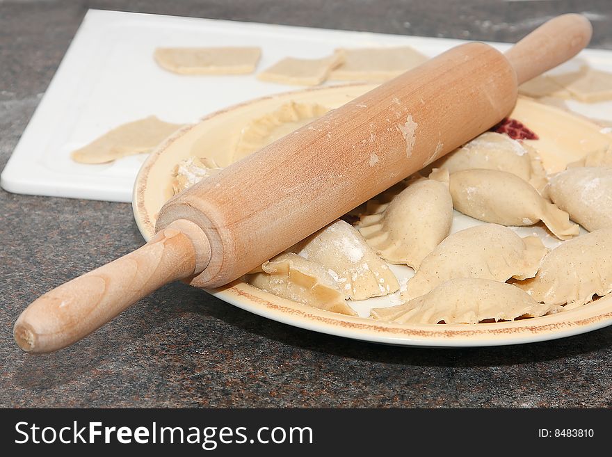 Rolling pin and ravioli on the plate