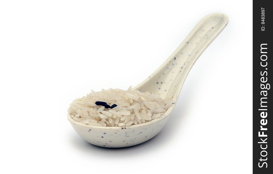 Spoon filled with white rice. Spoon filled with white rice