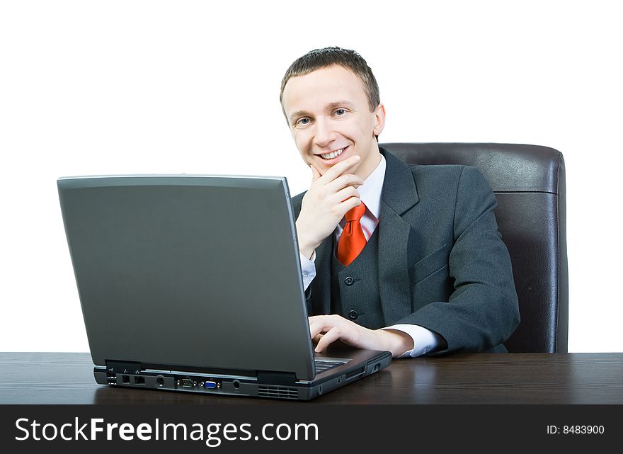 Happy young manager sitting at a desk and looking straight ahead. Happy young manager sitting at a desk and looking straight ahead