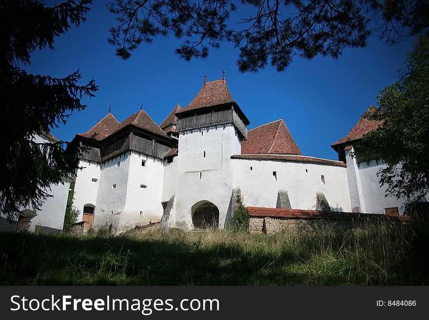 Ancient fortified church apon blue ski. Ancient fortified church apon blue ski