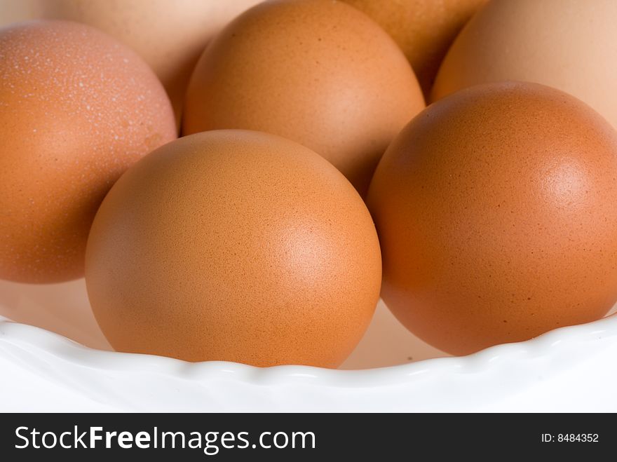Close-up eggs on plate, isolated over white