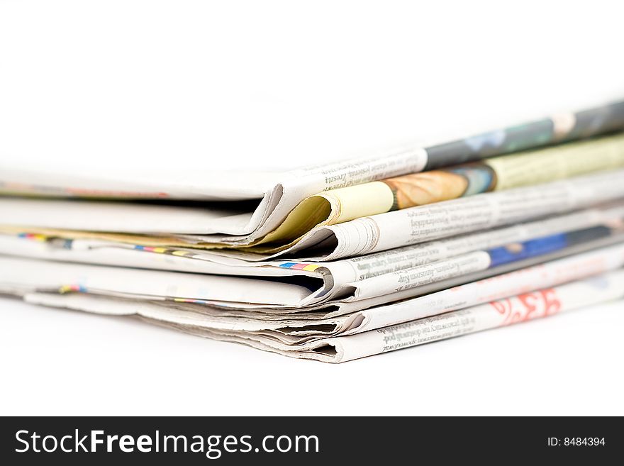 Stack of newspapers in color isolated on white background