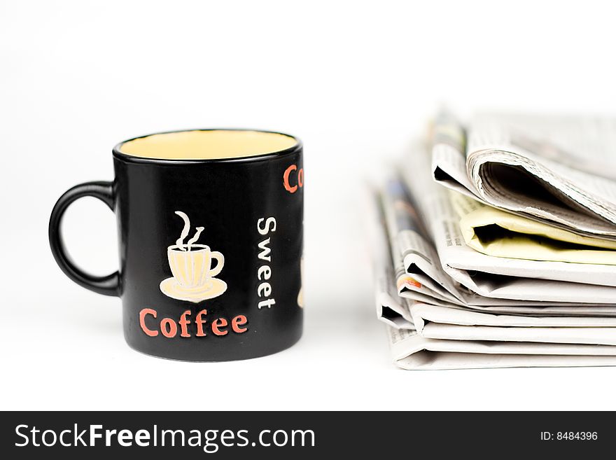 Coffee cup and stack of newspapers isolated on white background